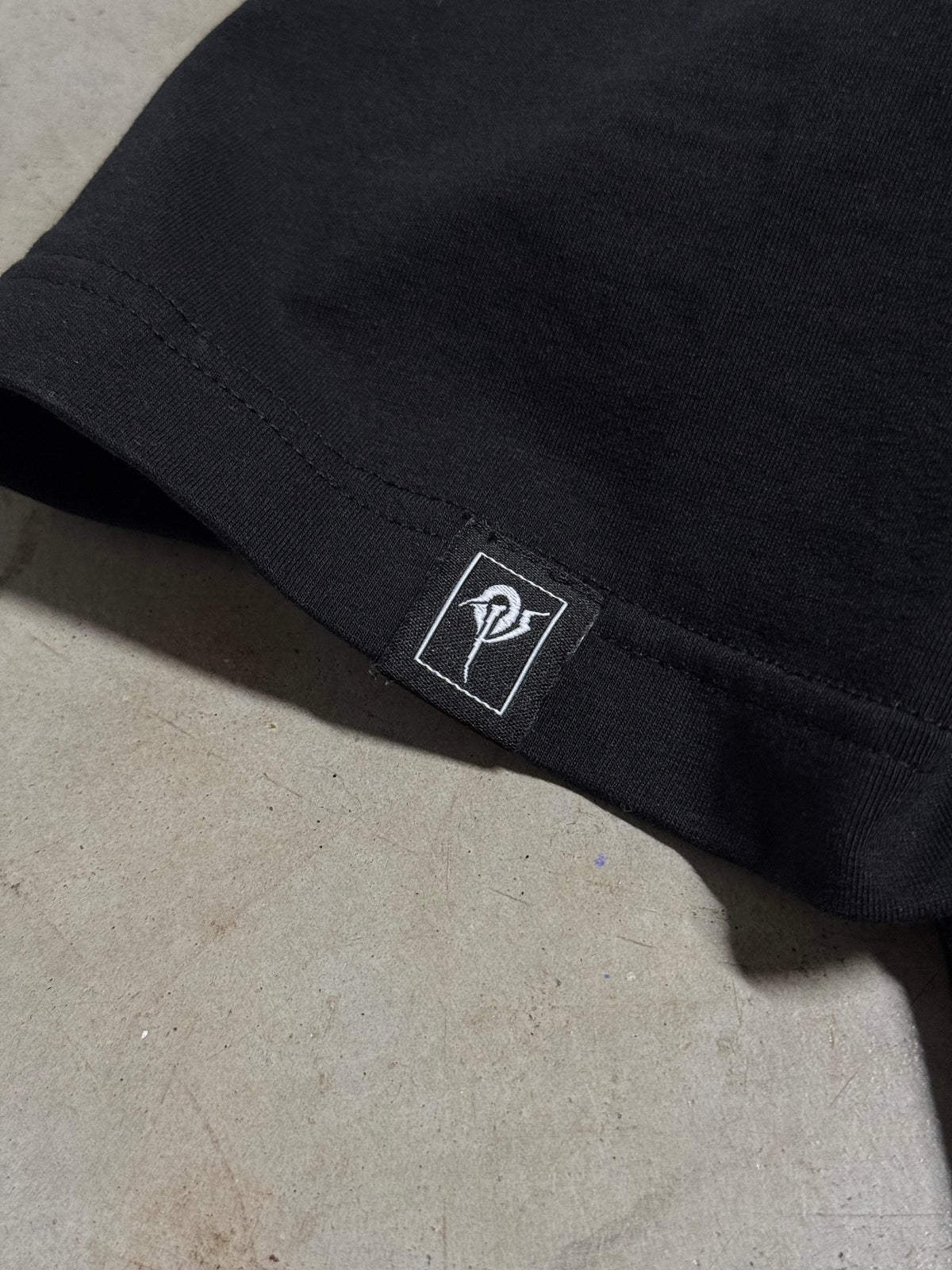 Small OP patch on the sleeve hem of the OverPower oversized tee