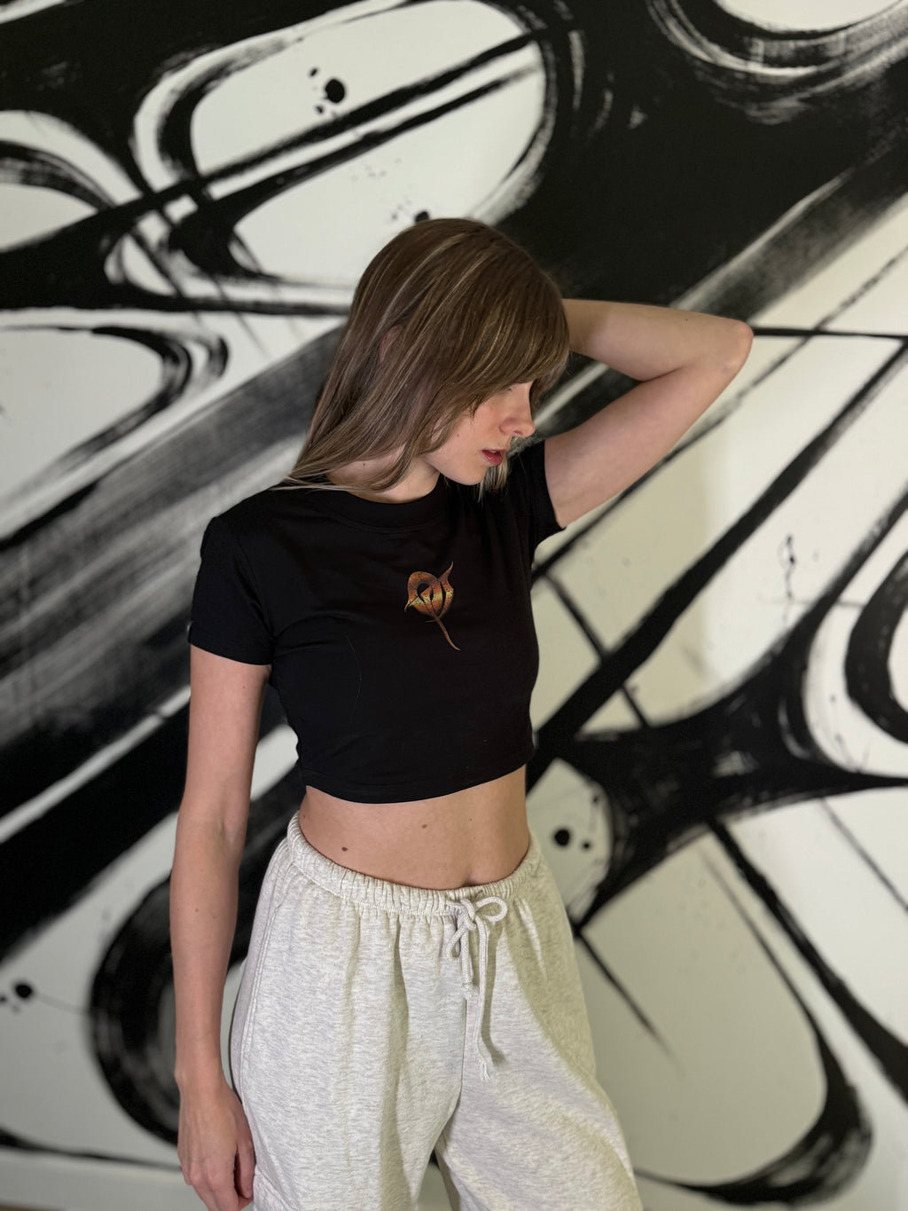 OverPower Strength Wear black crop tee worn, front view with the small OP monogram