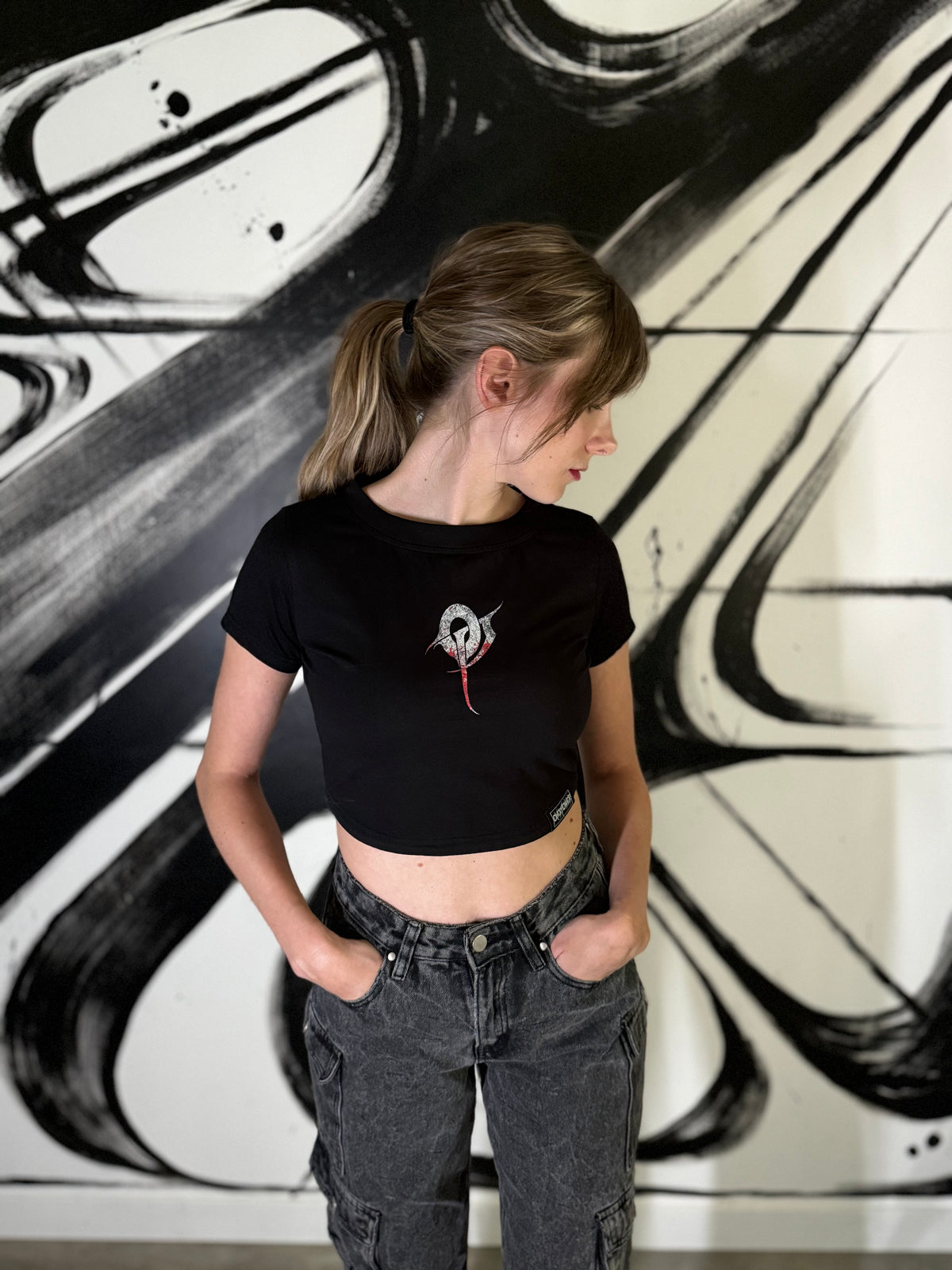 OverPower Strength Wear black crop tee worn, front view with the small OP monogram