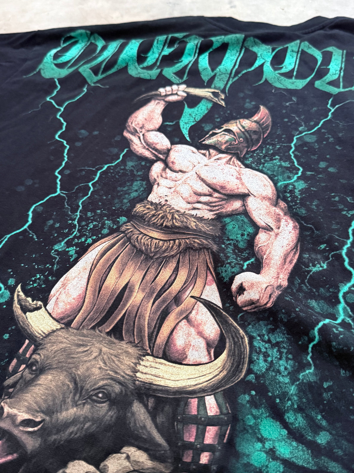 Close-up of the Hercules and the Horn of Abundance back print: Hercules in a crested helmet holding the horn over the bull