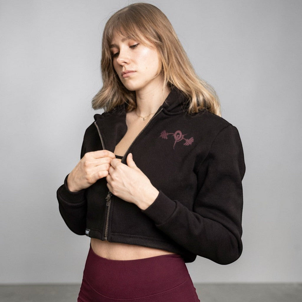 OverPower Strength Wear black cotton fleece crop zip-up hoodie with custom metal zipper and graphic detail.
