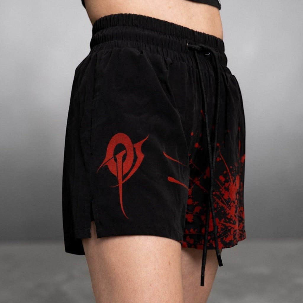 OverPower Strength Wear black unisex MMA shorts with red graphic print and blood splatter design. Nylon/spandex blend.