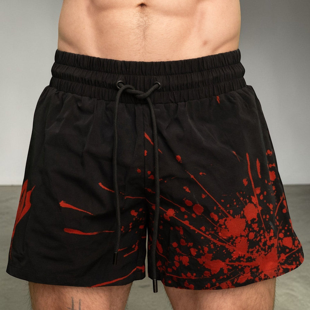 OverPower Strength Wear black unisex fighter shorts with red blood splatter graphic, nylon/spandex blend.